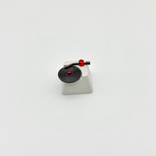 Record player custom keycap front view showing CNC machined vinyl grooves and vacuum plated tonearm