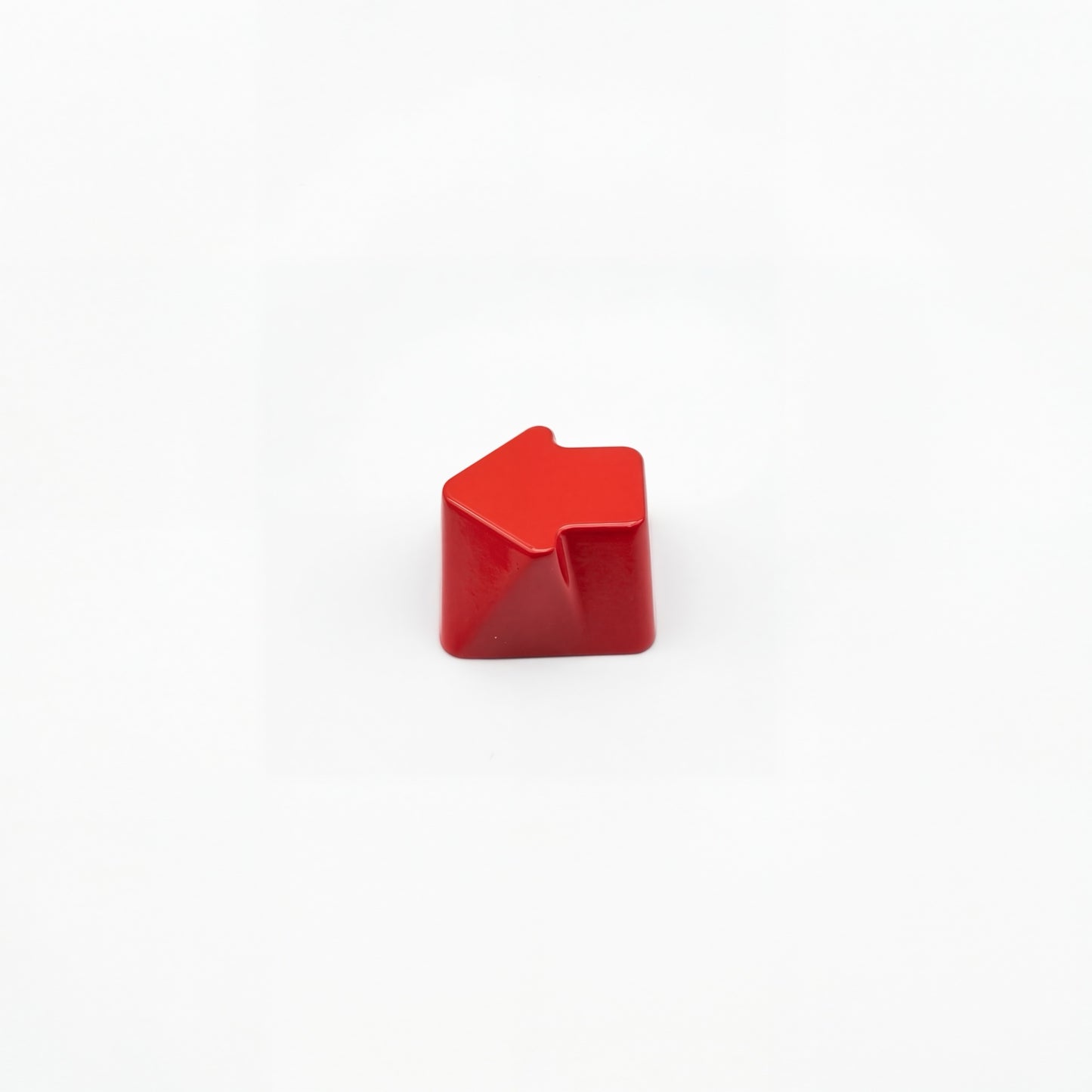Sculpted arrow custom keycap crimson red die-cast metal smooth lacquer top view on white background