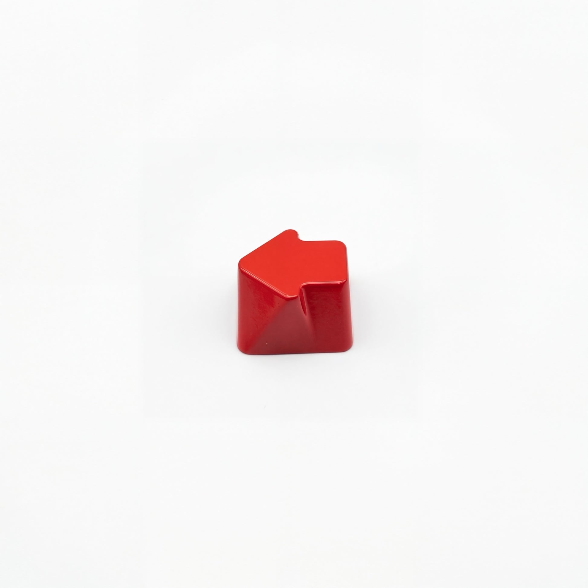 Sculpted arrow custom keycap crimson red die-cast metal smooth lacquer top view on white background