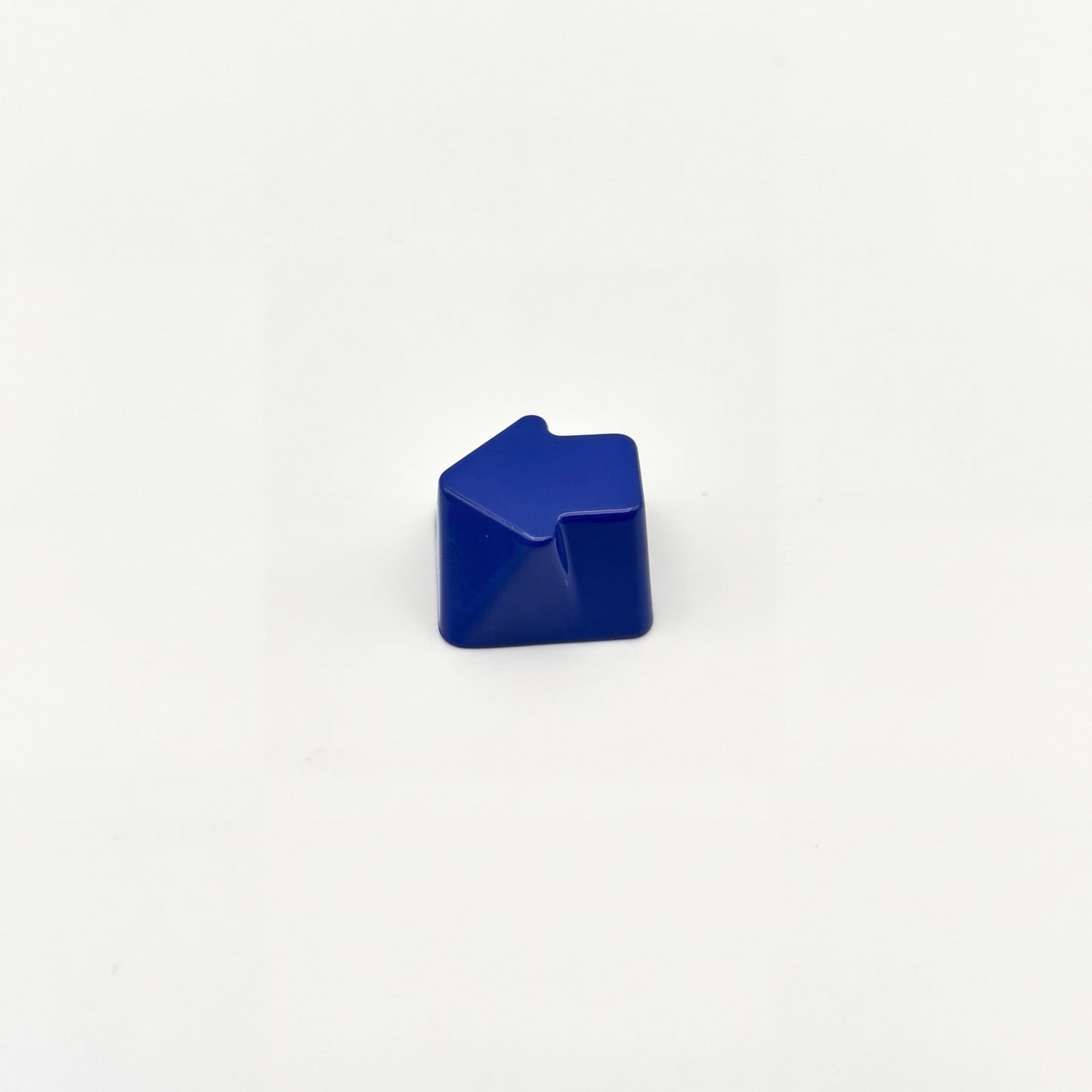 Sculpted arrow custom keycap navy blue die-cast metal smooth lacquer top view on white background
