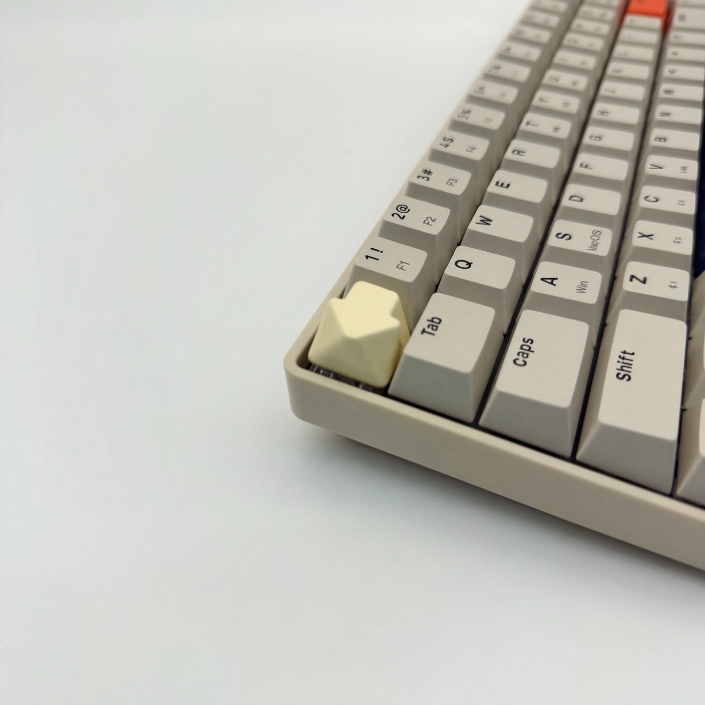 Arrow keycap cream white installed on ESC key mechanical keyboard side view clean setup