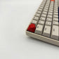Arrow keycap crimson red installed on ESC key mechanical keyboard side view bold accent