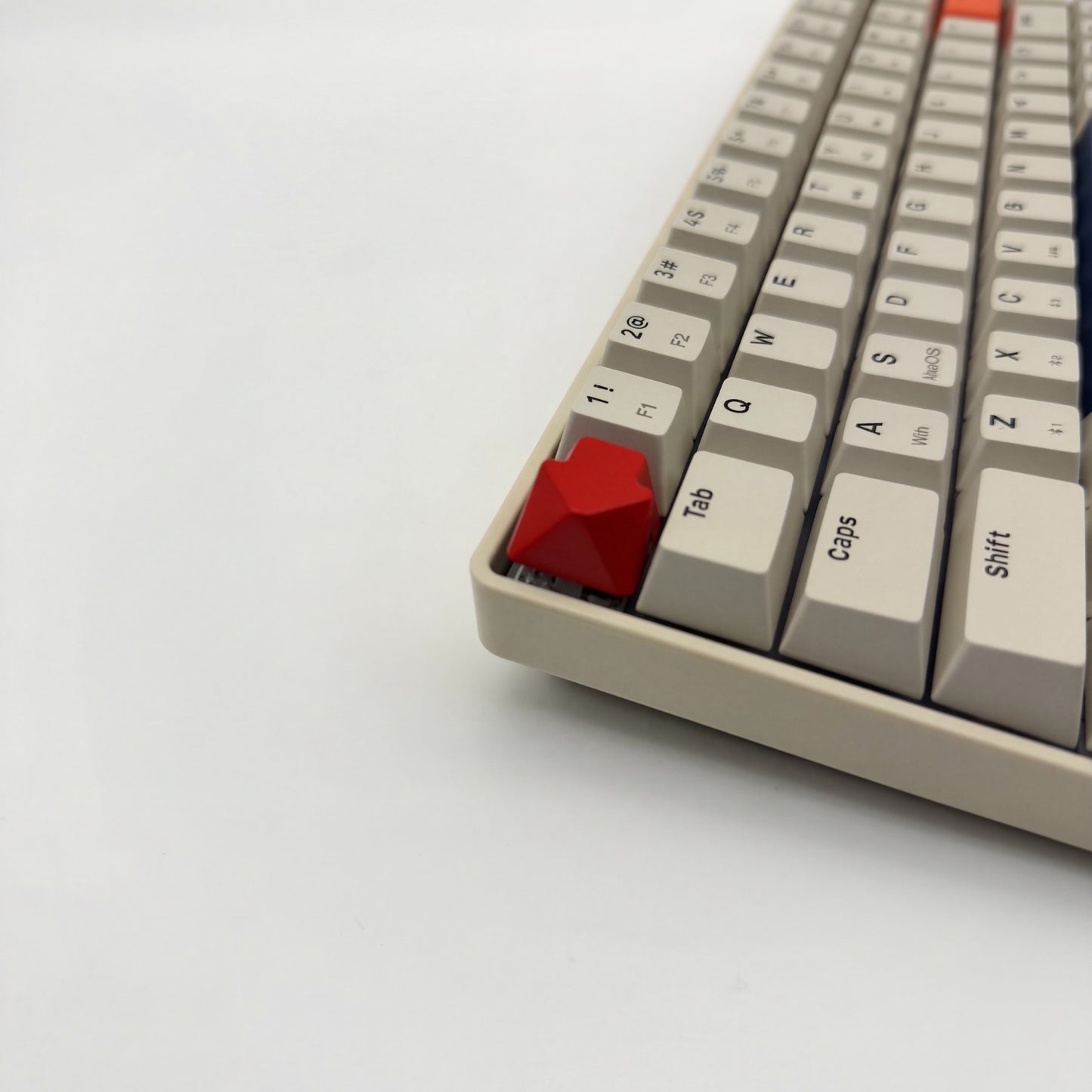 Arrow keycap crimson red installed on ESC key mechanical keyboard side view bold accent