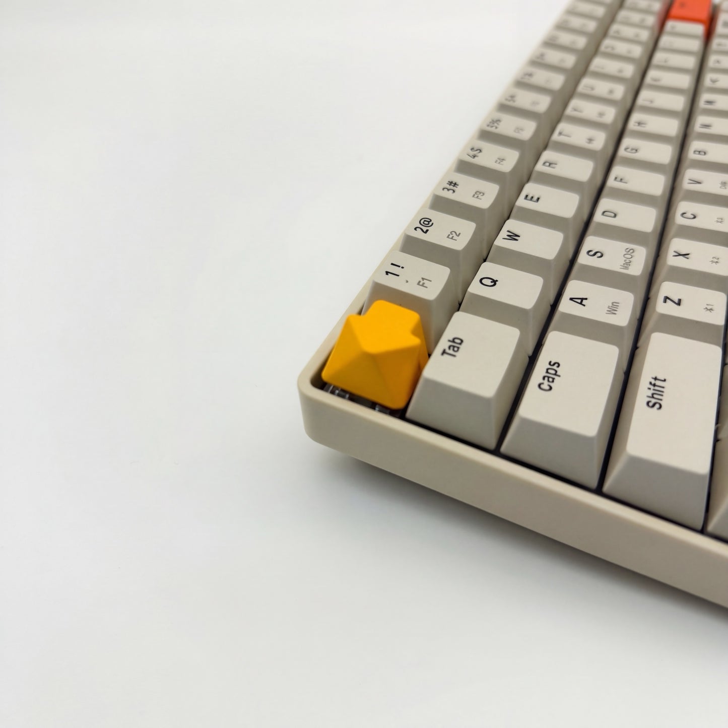 Arrow keycap golden yellow installed on ESC key mechanical keyboard side view clean setup
