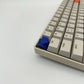 Arrow keycap navy blue installed on ESC key mechanical keyboard side view clean setup