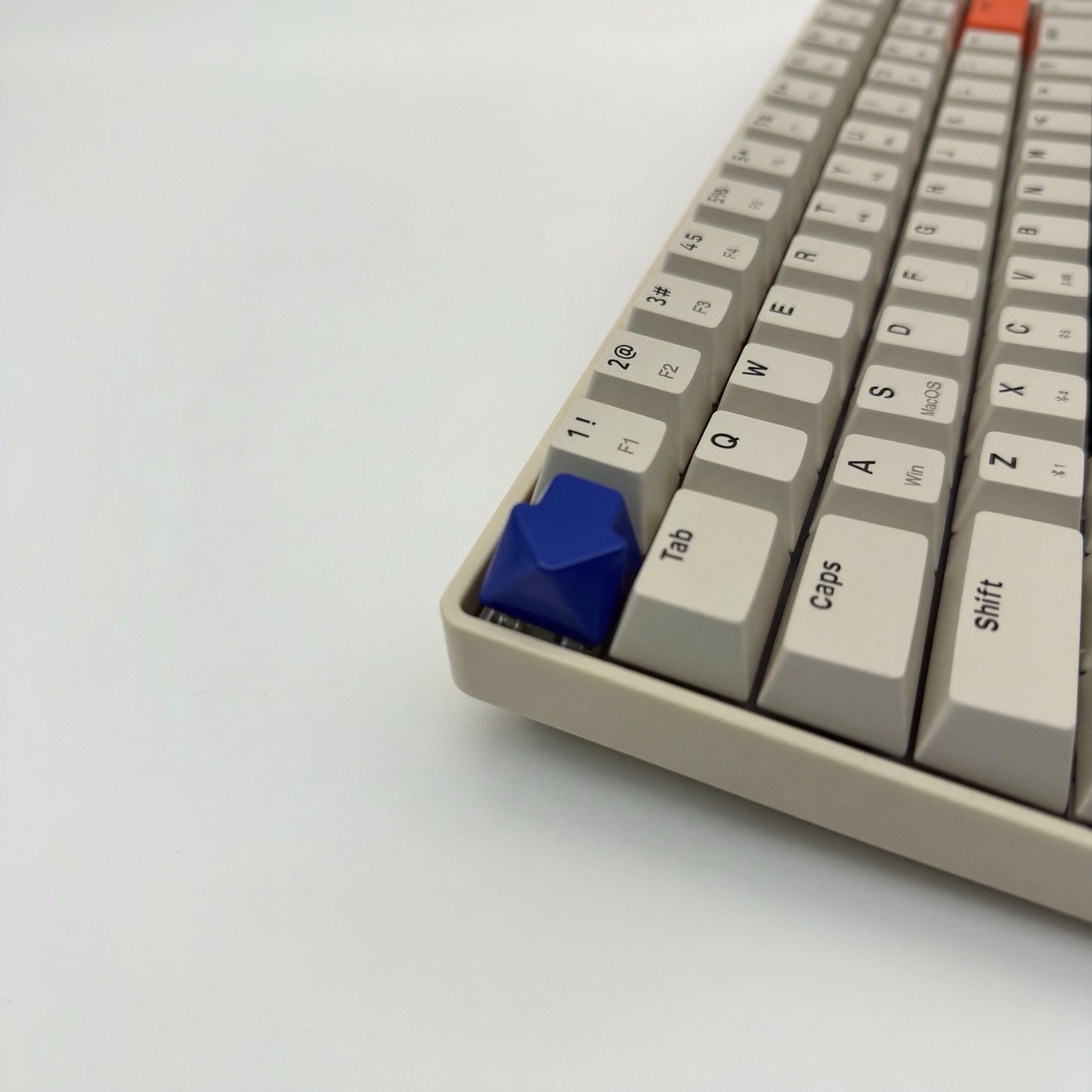 Arrow keycap navy blue installed on ESC key mechanical keyboard side view clean setup