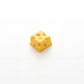 Matte yellow cheese custom keycap side view with Swiss cheese holes detail