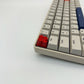 Hashtag artisan keycap red zinc alloy on mechanical keyboard side view showing sculpted hash detail
