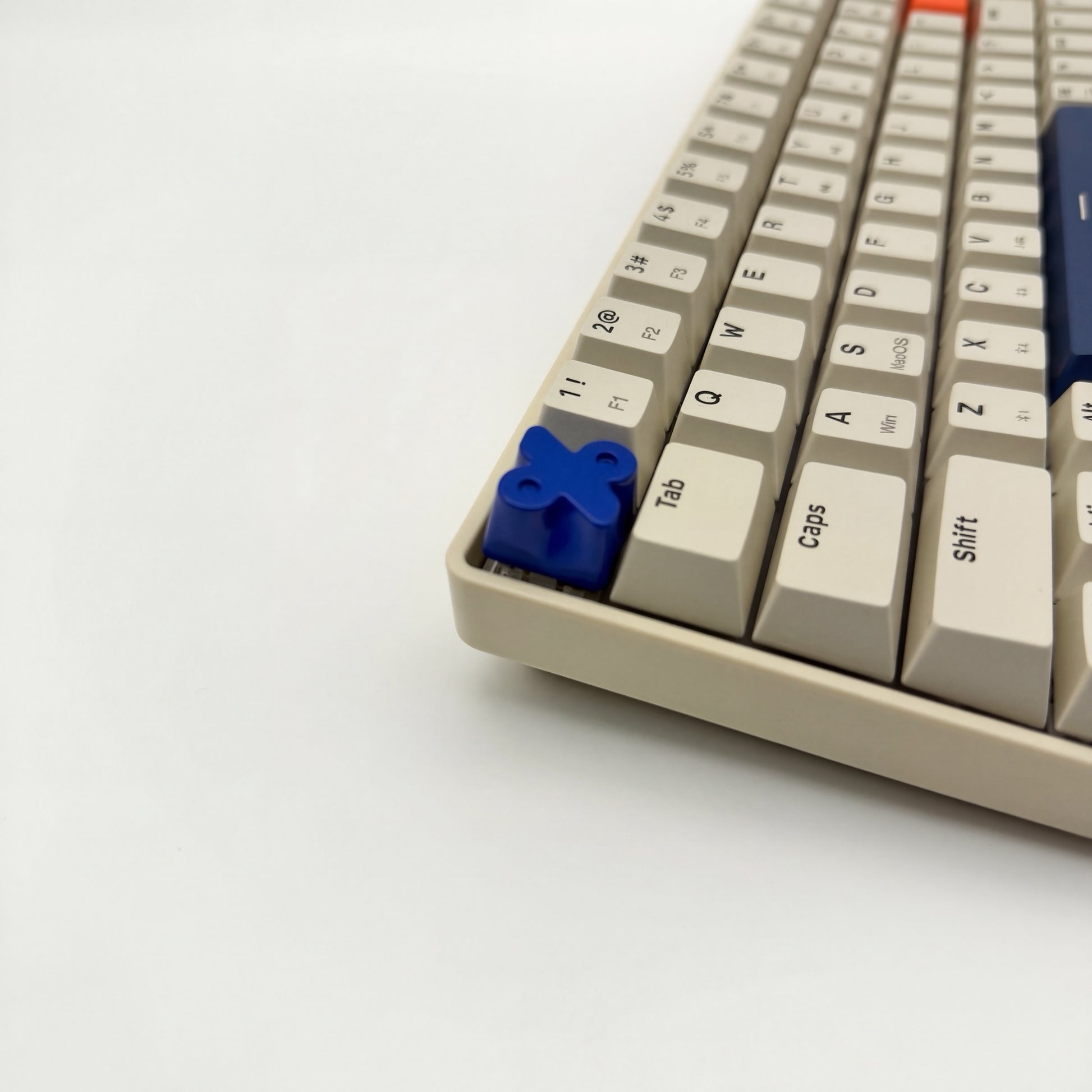 Blue percent artisan keycap zinc alloy on mechanical keyboard side view showing sculpted symbol detail