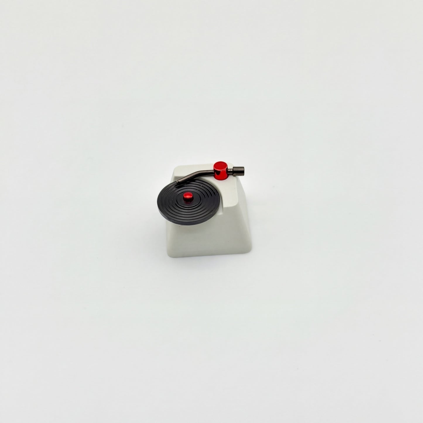 Record player custom keycap front view showing CNC machined vinyl grooves and vacuum plated tonearm
