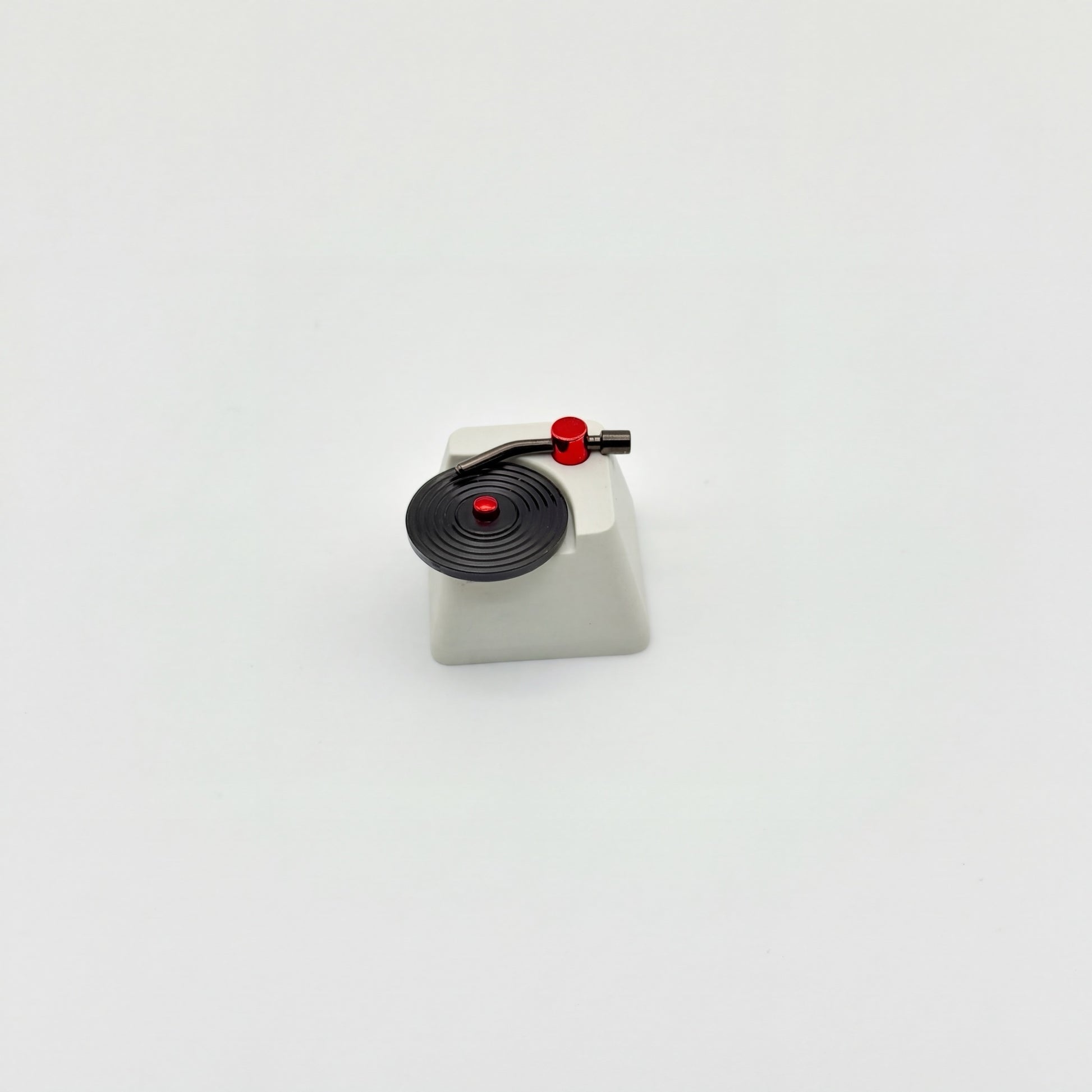 Record player custom keycap front view showing CNC machined vinyl grooves and vacuum plated tonearm