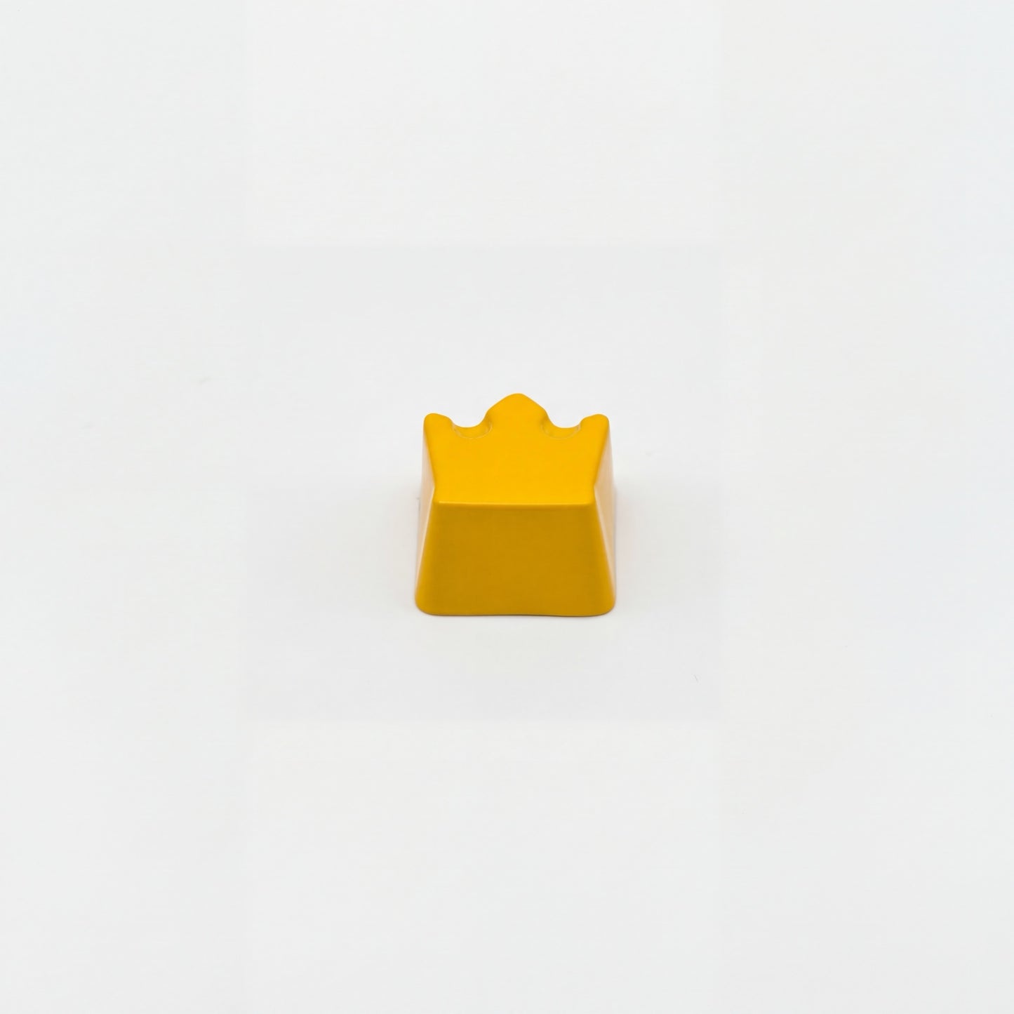 Sculpted royal custom keycap yellow die-cast metal lacquer finish front view on white background