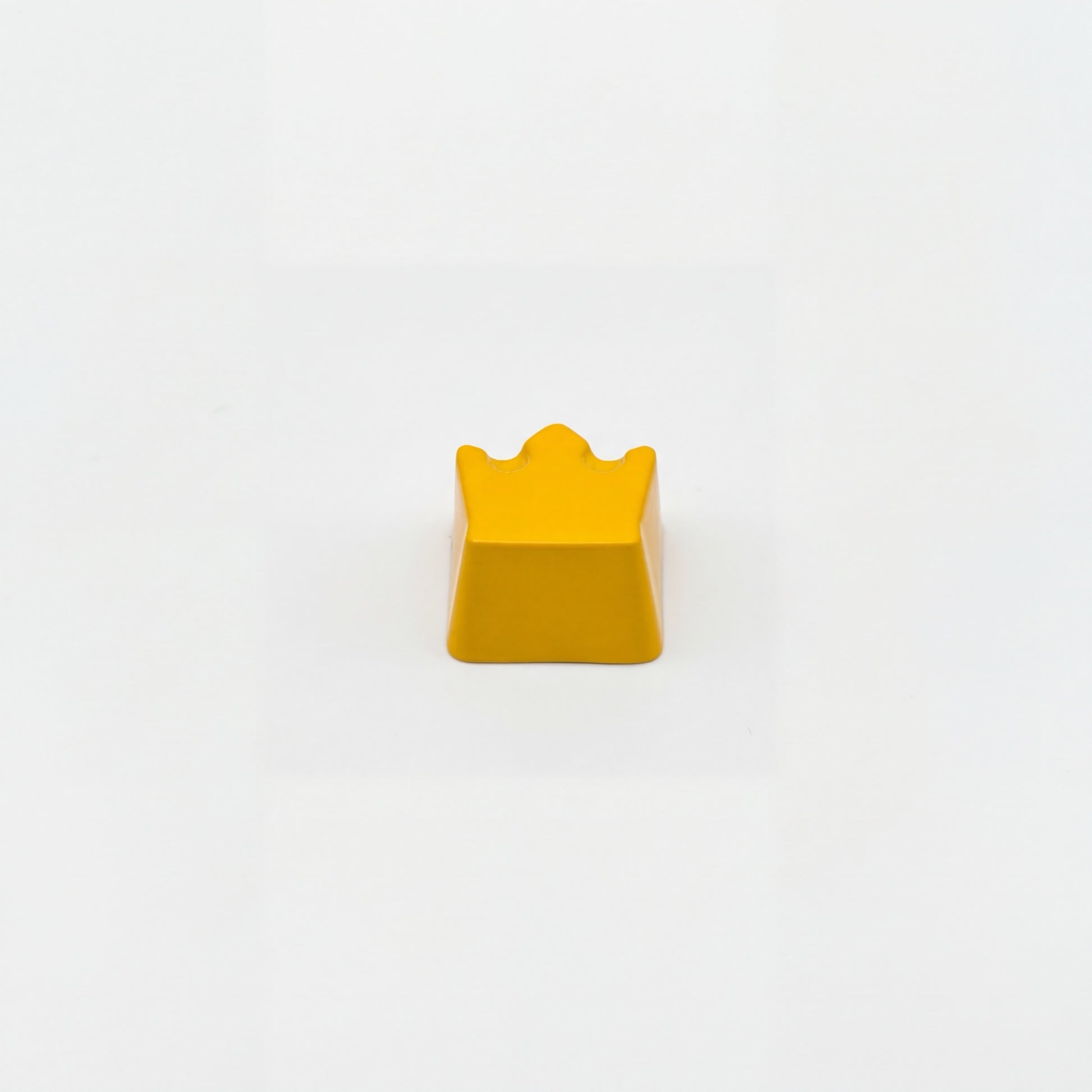 Sculpted royal custom keycap yellow die-cast metal lacquer finish front view on white background