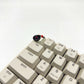 Spinning vinyl record artisan keycap on ESC key of mechanical keyboard close up side view